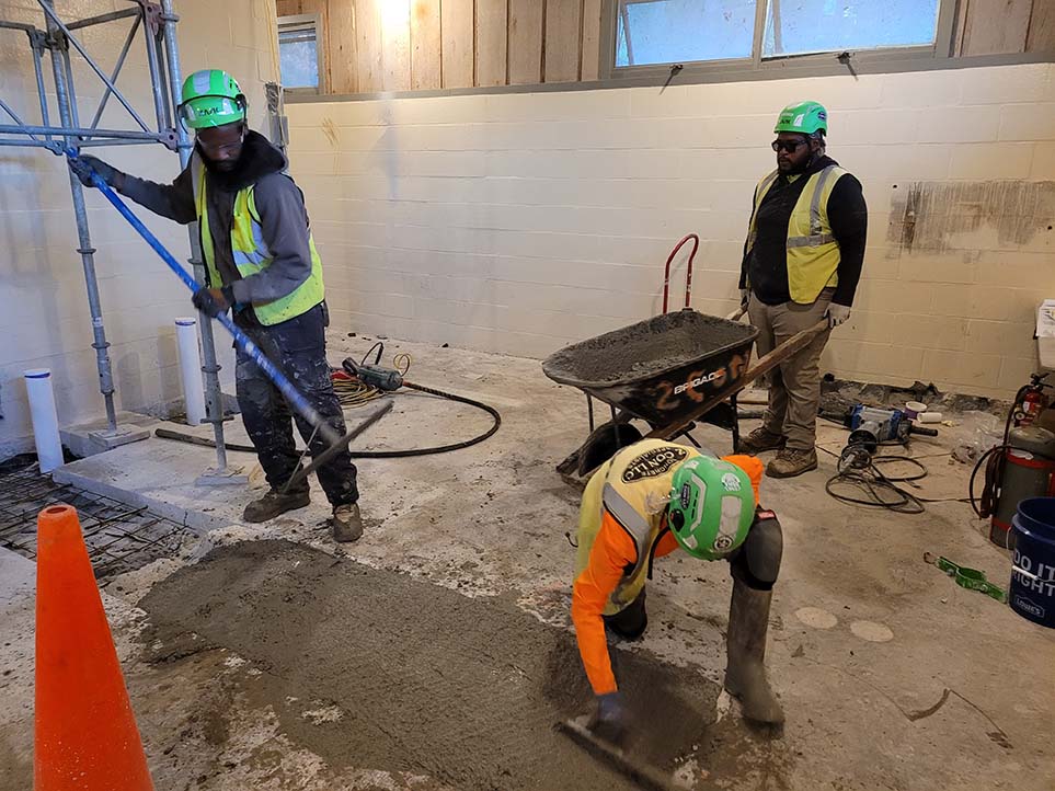 commercial concrete finishers work on public restroom